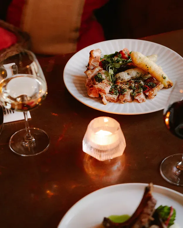 Sharing plates and candlelight on a table at The Griffin